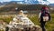 A tourist passing a milestone on a mountain trail