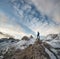 Tourist on the peak of high rocks of Italy mountains