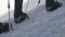 Tourist people in crampons walking on snow trail in mountain close up