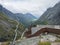 Tourist people at view point platform on Trollstigen or Trolls Path with green valley at massif Trolltindene in Romsdal