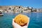 Tourist person holding local Greek Symi island sea sponge.