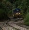 Tourist person standing on railroad railway train track safety danger crossing at Aguas Calientes Macchu Picchu Peru