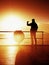 Tourist photograph on sea mole. Hiker take photos of morning sea. Autumn fog. Tourist on wooden board in wharf, Sunny sky, sm