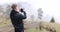 Tourist photographer takes pictures of nature with digital camera