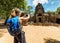 Tourist photographing the ancient gopura in Angkor, Cambodia