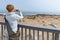 Tourist photographing the seal colony at Cape Cross, on the atlantic coastline of Namibia, Africa. Selective focus on display of