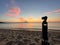 Tourist photographing the sunrise. Before sunrise in Sarti, Greece, with Mount Athos in the background