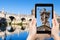 Tourist photographs Angel statue on bridge in Rome