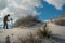 A tourist photographs and filming the wavy dunes of gypsum sand