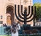 The tourist photographs a Menorah standing at the entrance to the synagogue Coral in Bucharest city in Romania