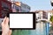 tourist photograps bridge and canal in Venice