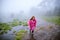 Tourist with pink rain coat walking travel adventure nature in the rain forest. travel nature, Travel relax, Travel Thailand,