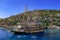 Tourist pirate schooner on the background of the Old City in Alanya Turkey. Vintage wooden ship with two masts in the