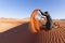 Tourist playing sand in Wadi Rum Desert, Jordan