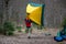 A tourist raised a yellow tent over his head