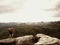 Tourist in red black sportswear, green backpack on view point watch landscape.