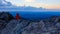 Tourist in red jacket watching dawn from high attitude