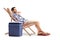 Tourist relaxing in a deck chair next to a cooling box