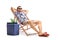 Tourist relaxing in a deck chair next to a cooling box