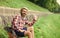 Tourist relaxing in park drink tea or coffee. Coffee on the go. man with a cup of coffee outdoors. Handsome calm bearded