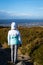 Tourist resting after a hike and enjoying the beautiful view of Dublin, green rolling Irish hills and mountain peaks.