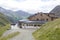 Tourist are resting near Luckner-Haus or Lucknerhutte near the Grossglockner rock summit in Austrian Alps, Kals am Grossglockner,