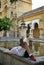 Tourist resting, Patio de los Naranjos at Mosque in Cordoba, Spain