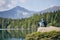 Tourist resting on rock above lake