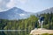 Tourist resting on rock above lake