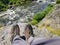 Tourist resting on a stone, legs outstretched