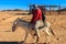 Tourist ride donkey in Arabian desert, Egypt