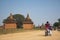 Tourist ride electric bicycle take picture landscape of Bagan Historical Pagoda Travel Asia