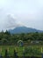 Tourist riding an air bike in Ghanjaran Eco Park with a view of Mount Bulak, Mojokerto, Indonesia