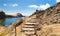 The tourist rises on steps in the rock on an ocean coast, on Mad