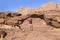 Tourist on rock. Wadi Ram desert. Stone bridge. Jordan landscape