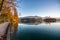 Tourist route on the wooden floor along the famous alpine Bled lake (Blejsko jezero) in Slovenia, amazing autumn