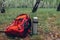 Tourist`s backpack, thermos with tea in spring forest. Traveling and sport