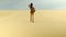 tourist in safari style walks through the sandy desert, the scorching sun shines