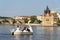 Tourist sailing on pedal boats on Vltava river near Charles bridge in Prague, Czech Republic