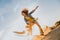 Tourist Sandboarding girl In the Desert Man jumps in and does the trick