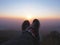 Tourist selfie feet over sunrise sky background on the high mountain