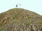 Tourist on sharp basalt peak of volcano formation