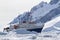tourist ship among the icebergs on the background of the mountains of the Antarctic Peninsula