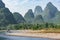 Tourist ship moves along the karst hills. Li River