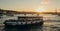 Tourist ship sails on the Golden Horn, scenic sunny beautiful waterfront  of Istanbul city at sunset in summer