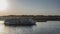 Tourist ships sail on a calm river.