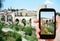 Tourist shoots photo of bridge in Besalu town