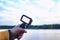 Tourist shoots a video on an action camera against the backdrop of nature and the river. Close-up of a white screen mockup on the