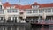 Tourist sightseeing boat on waterway by Amsterdam tourist information and cafe.