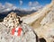 Tourist sign and stone pyramid in Dolomites alps